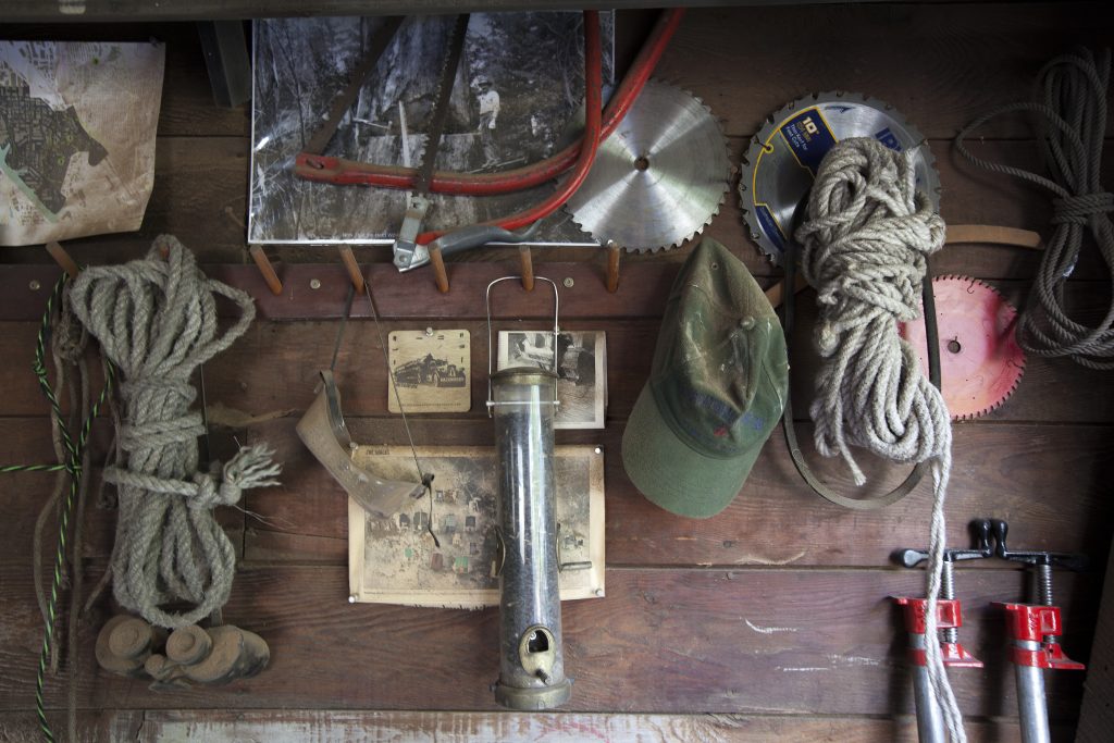 Tools and vintage photos hanging on a wall in birdloft workshop