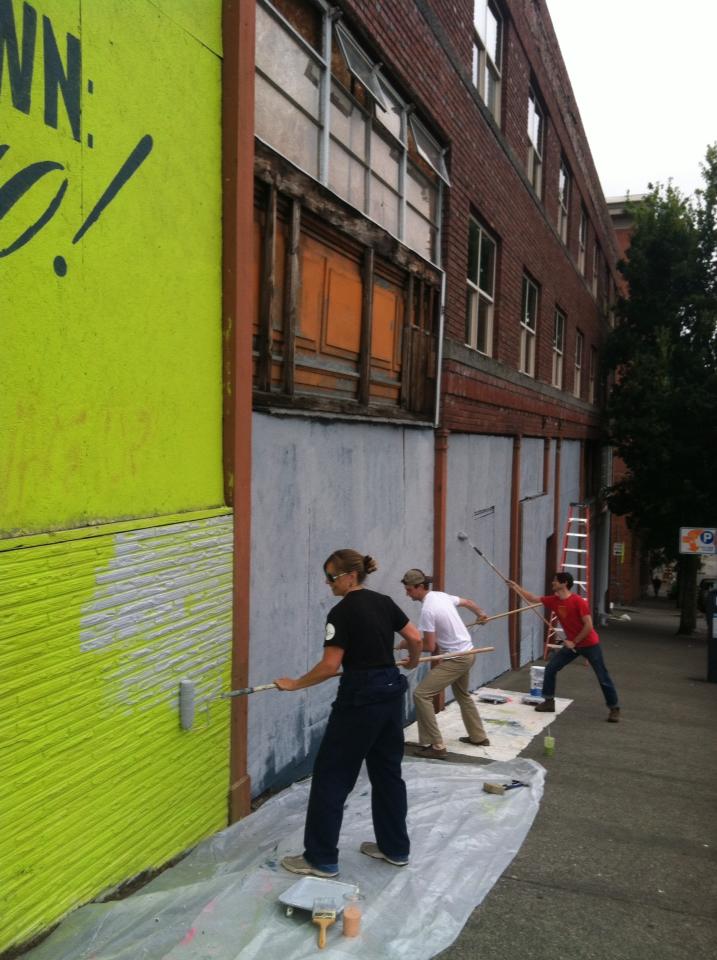 Heather Joy and volunteers prepare a wall for new mural in Tacoma